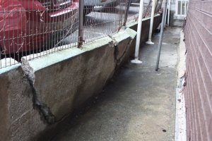Damaged fence and retaining wall.jpg